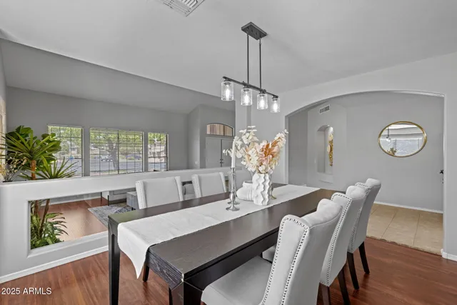 a living room with furniture a couch and paintings on the wall
