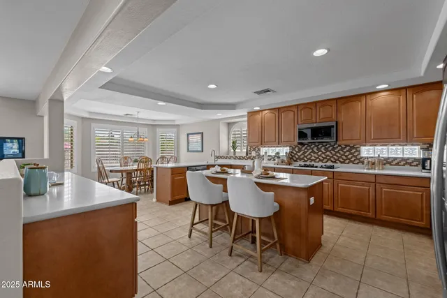 a spacious bathroom with a double vanity sink a mirror and a bathtub