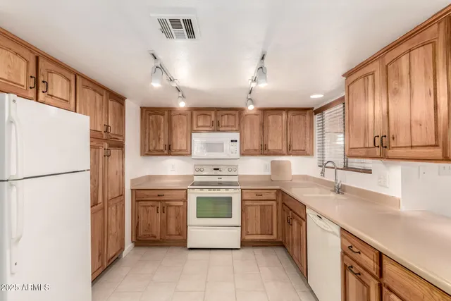 a kitchen with a sink a refrigerator and a oven