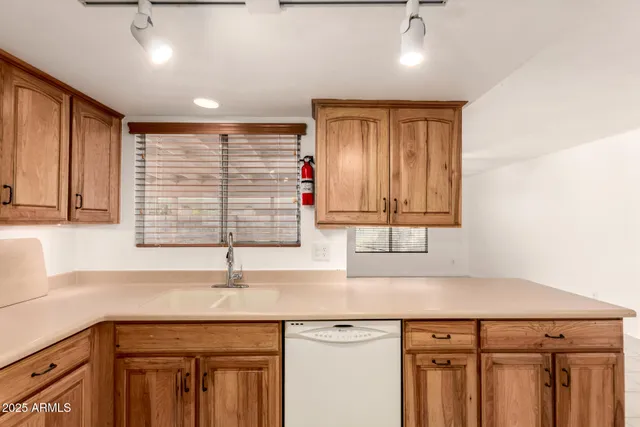 a kitchen with a sink cabinets and window