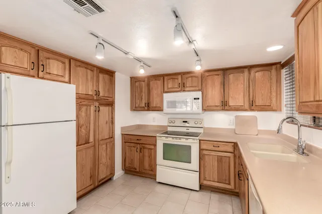 a kitchen with a sink appliances and cabinets
