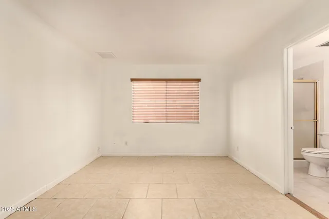 a bathroom with a toilet sink vanity and mirror