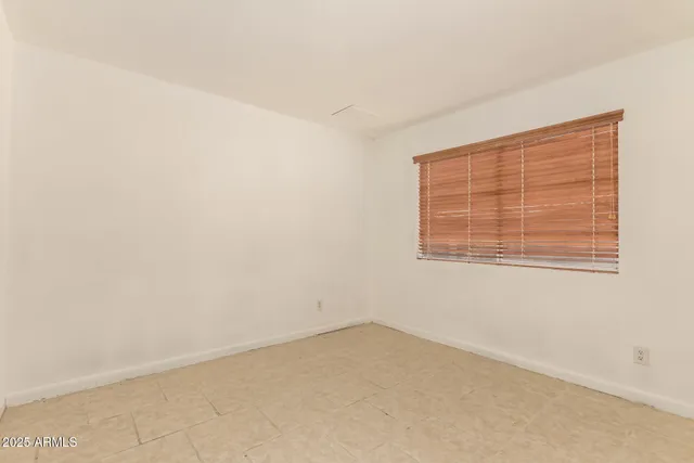 a bathroom with a granite countertop toilet sink and a mirror