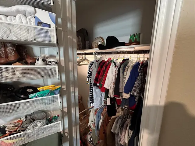 a kitchen with refrigerator and chairs