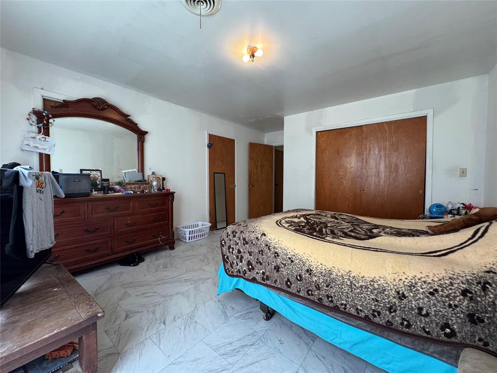 733 Foster Street Marlin, TX 76661 - Photo 12 of 40 a bed room with a bed and a television