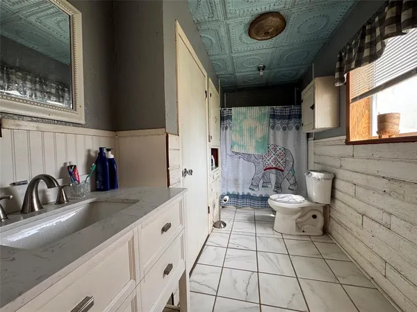 a bathroom with a sink a toilet and mirror