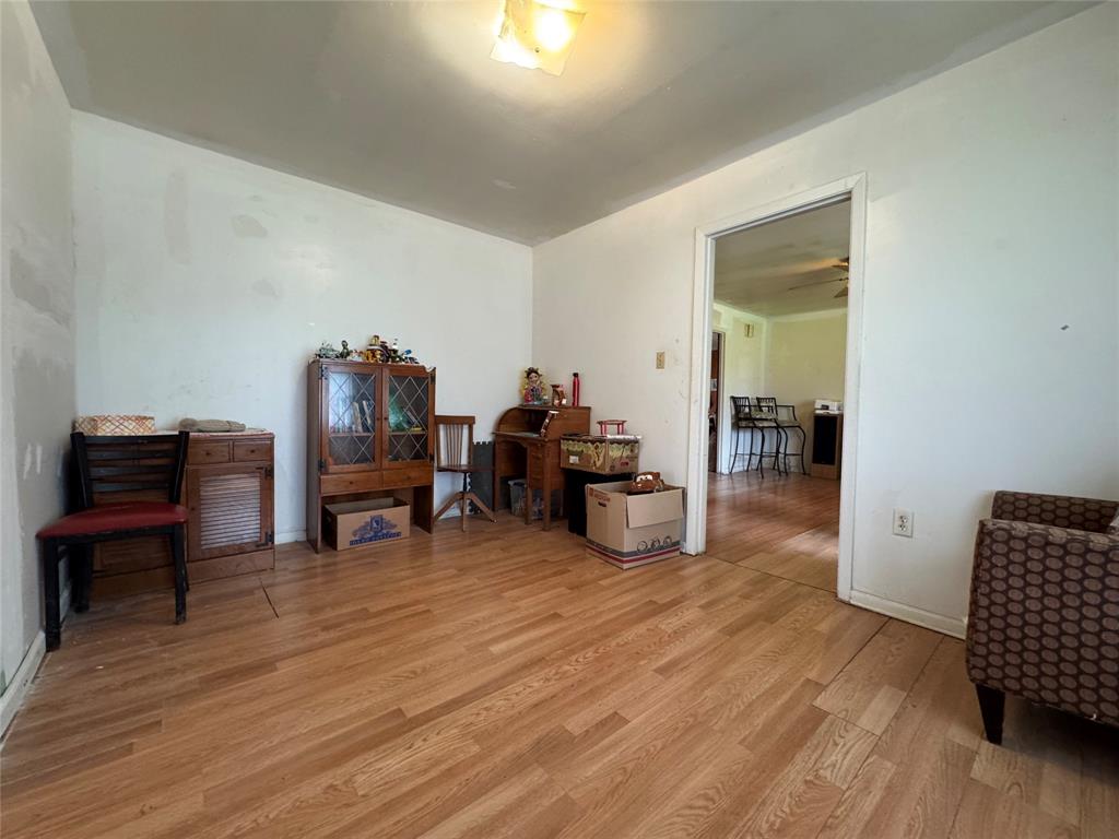 733 Foster Street Marlin, TX 76661 - Photo 22 of 40 a living room with furniture and a wooden floor
