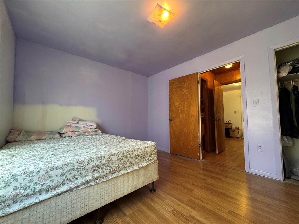 733 Foster Street Marlin, TX 76661 - Photo 25 of 40 a bedroom with a bed and a flat screen tv