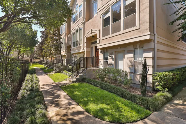 a view of a house with a backyard and tub
