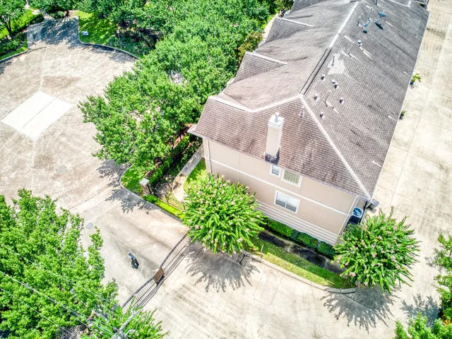 an aerial view of a house with a yard and garden