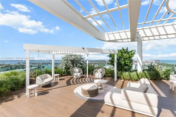 a building outdoor space with patio furniture and potted plants