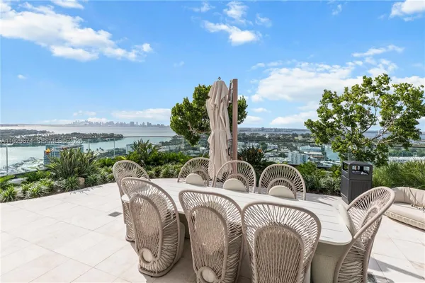 a view of a swimming pool with outdoor seating and plants