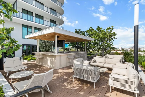a view of a patio with couches table and chairs and potted plants