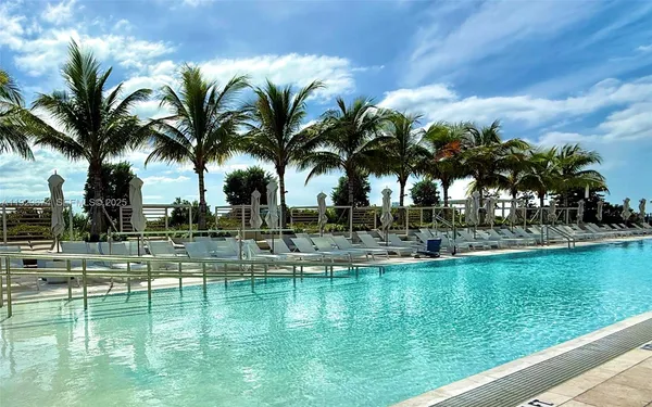 a view of swimming pool with a garden and plants