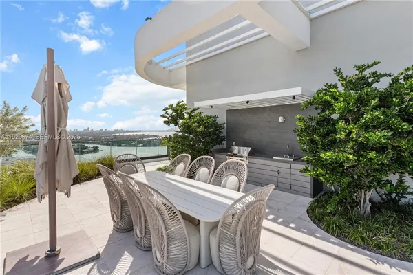 a view of balcony with furniture and garden