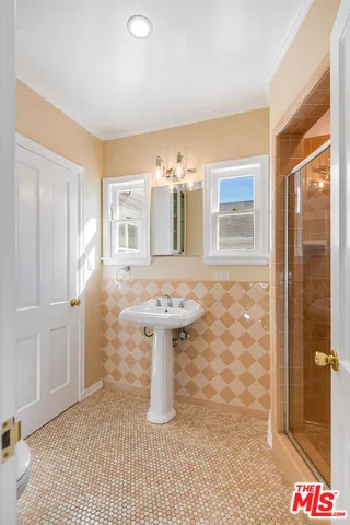 a front view of a house with a tree