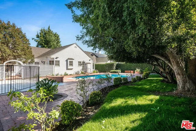 a bathroom with a double vanity sink mirror and shower