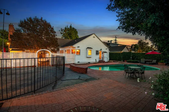 an outdoor space with furniture and umbrella
