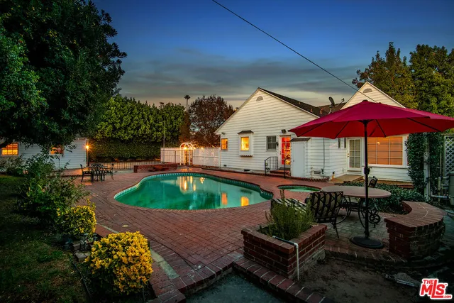 an outdoor space with pool table and chairs