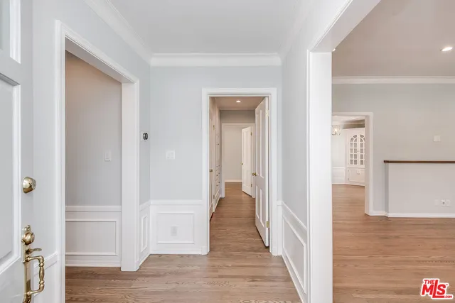 a view of an empty room with wooden floor fireplace and a window