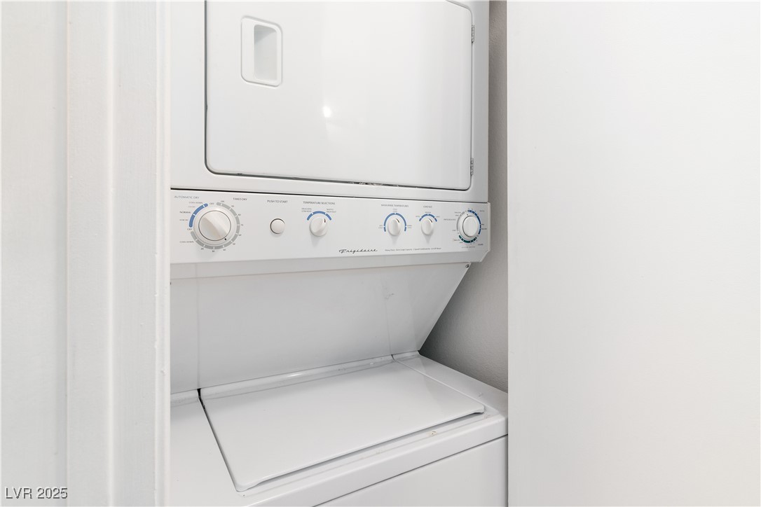 2192 Aspen Mirror Way, Unit 102 Laughlin, NV 89029 - Photo 21 of 58 Laundry closet featuring stacked washer / dryer, located in the hallway bathroom