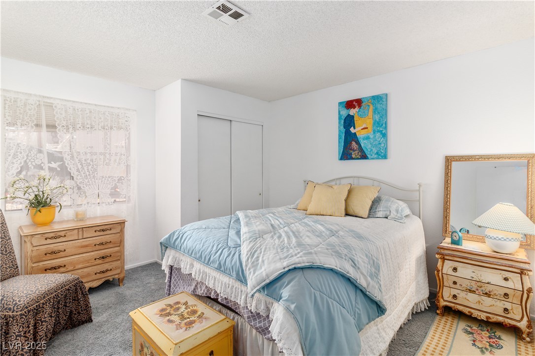 2192 Aspen Mirror Way, Unit 102 Laughlin, NV 89029 - Photo 25 of 58 Carpeted bedroom with a closet and a textured ceiling