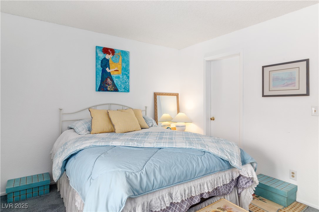 2192 Aspen Mirror Way, Unit 102 Laughlin, NV 89029 - Photo 26 of 58 Carpeted bedroom featuring baseboards
