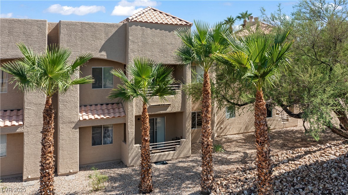 2192 Aspen Mirror Way, Unit 102 Laughlin, NV 89029 - Photo 49 of 58 Back of house featuring a tiled roof, stucco siding, and a patio area
