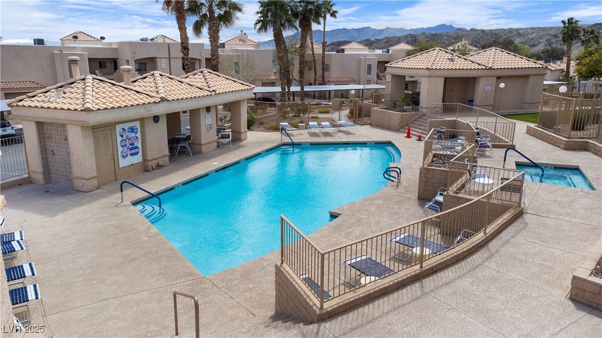 2192 Aspen Mirror Way, Unit 102 Laughlin, NV 89029 - Photo 54 of 58 Community pool featuring a patio area, a residential view, and a mountain view