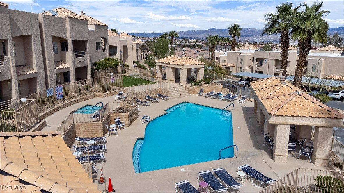 2192 Aspen Mirror Way, Unit 102 Laughlin, NV 89029 - Photo 57 of 58 Community pool featuring a residential view, a patio, and a mountain view