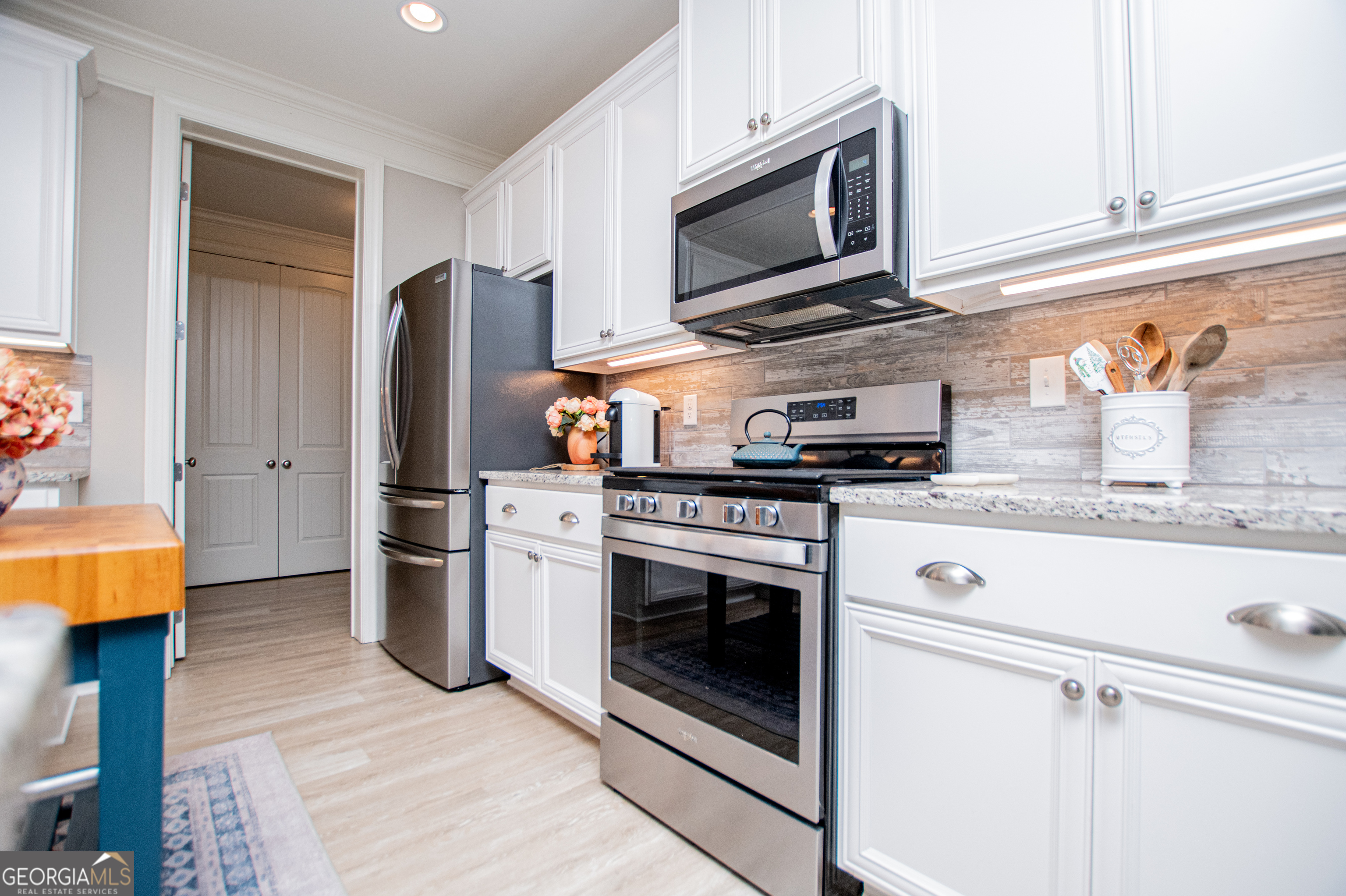 216 Yorkshire Lane Villa Rica, GA 30180 - Photo 28 of 94 a kitchen with stainless steel appliances granite countertop a stove microwave and refrigerator