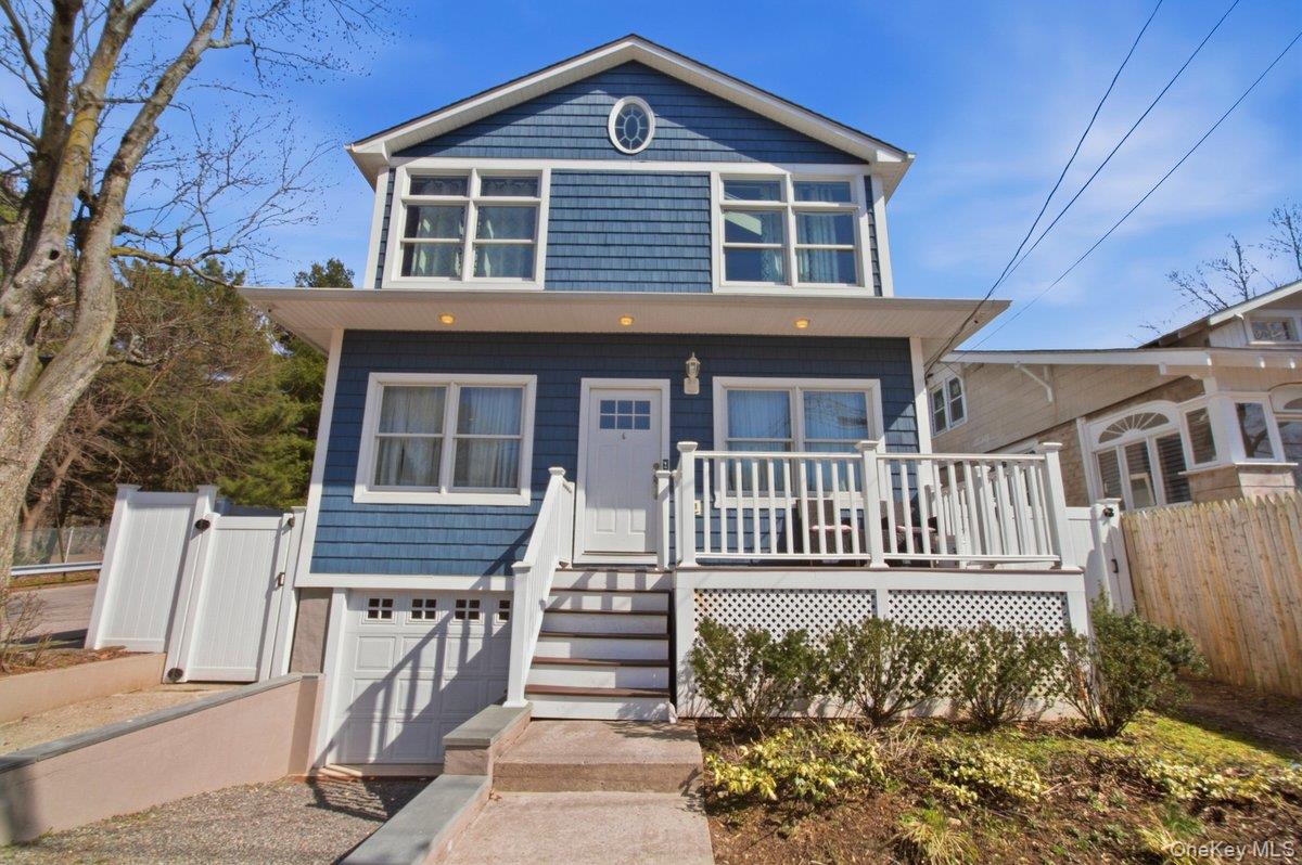 View of front facade featuring a garage and a Trex deck
