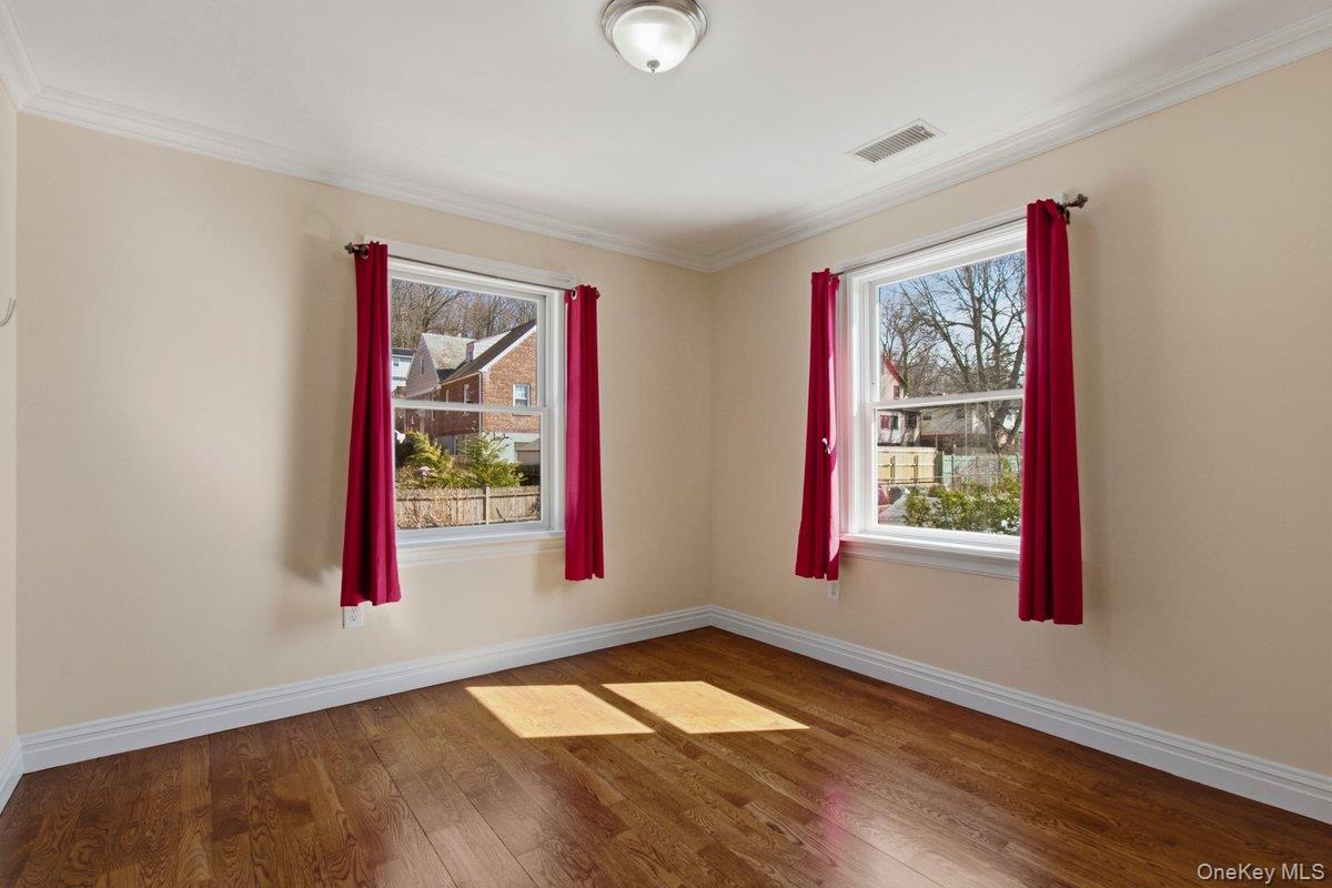 246 Tibbetts Road Yonkers, NY 10705 - Photo 12 of 27 Unfurnished room featuring wood flooring and ornamental molding