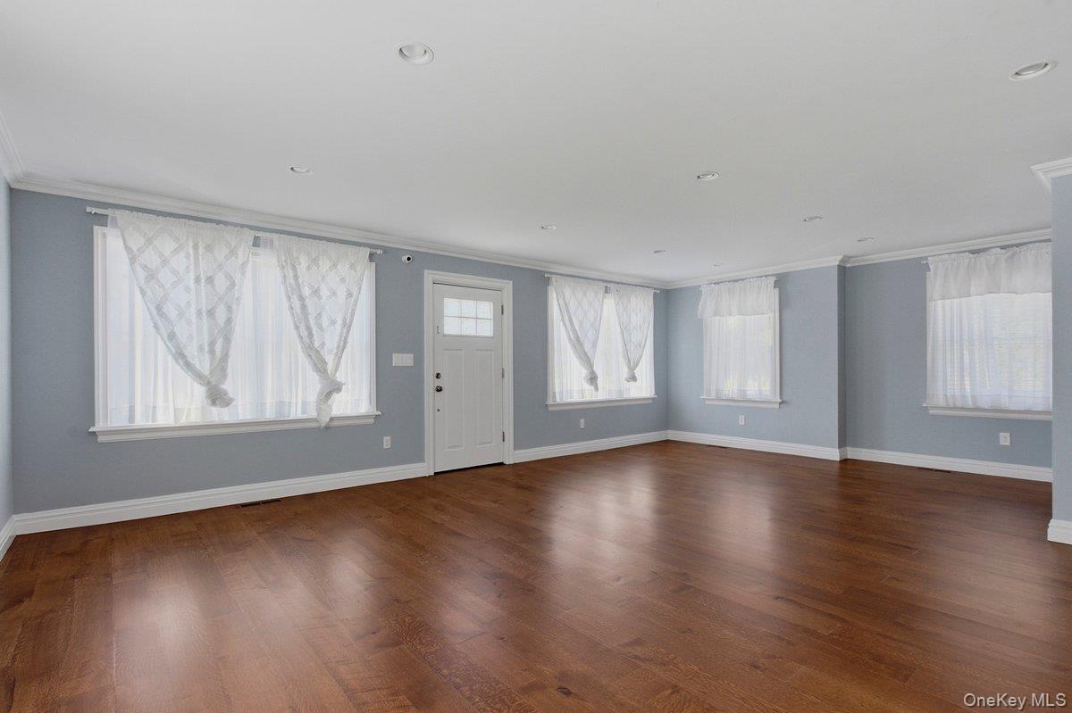 246 Tibbetts Road Yonkers, NY 10705 - Photo 3 of 27 Entryway featuring ornamental molding and dark wood-style flooring