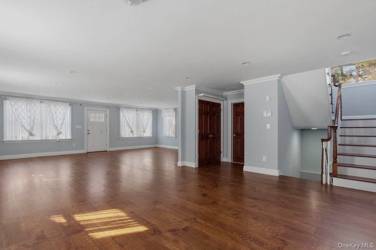 246 Tibbetts Road Yonkers, NY 10705 - Photo 4 of 27 Living room featuring dark wood-type flooring and crown molding