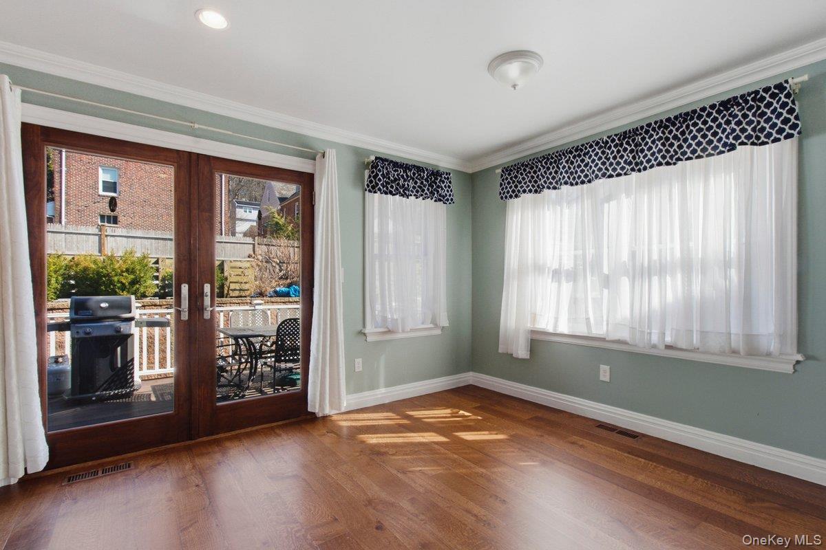 246 Tibbetts Road Yonkers, NY 10705 - Photo 7 of 27 Dining room with french doors, dark wood finished floors, and crown molding