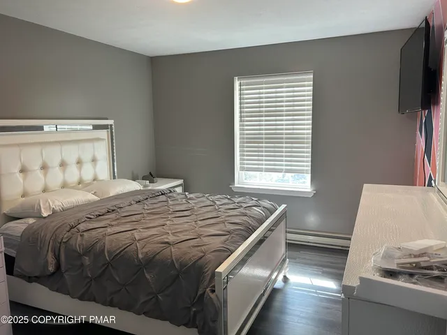 a bedroom with a bed and a flat screen tv