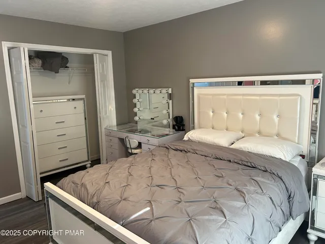 a bedroom with a bed and a dresser