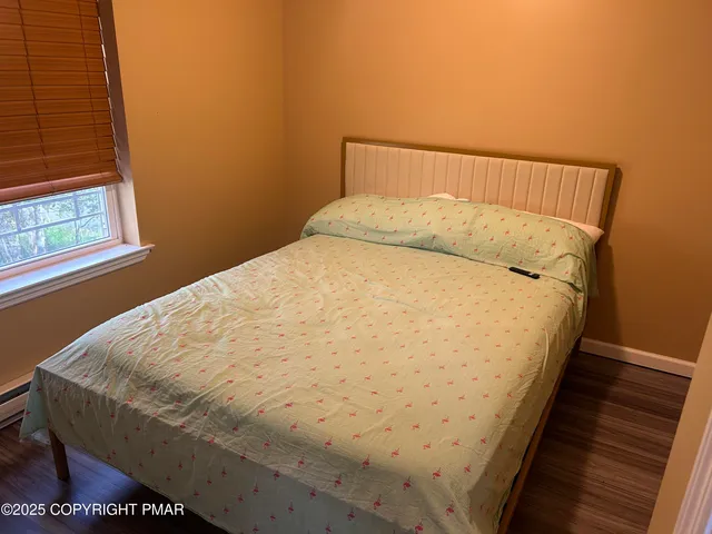 a bed sitting in a bedroom next to a window