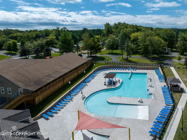 an aerial view of a house with a swimming pool