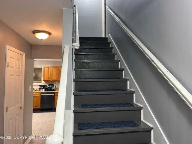a view of a kitchen and an entryway
