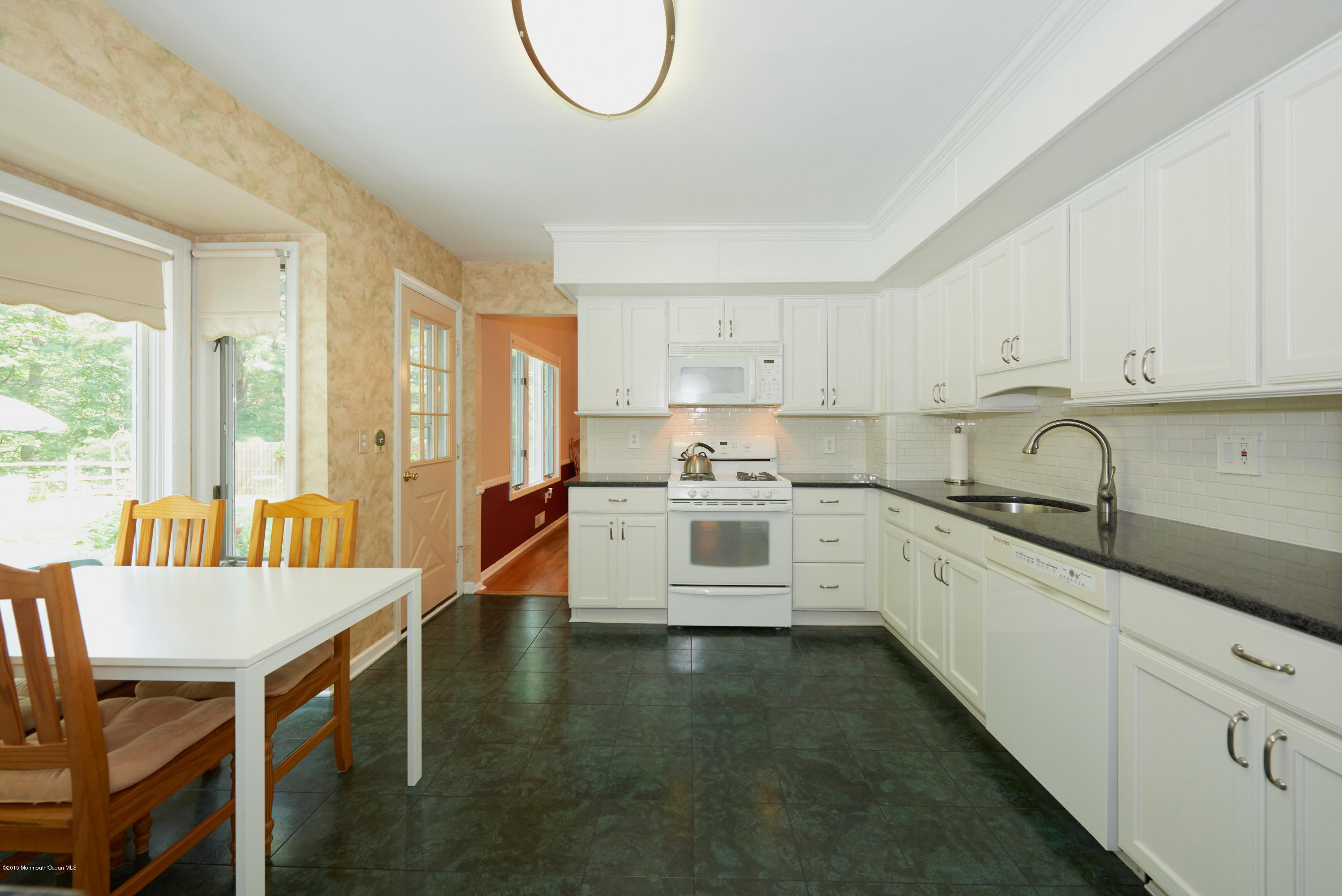 21 Crest Road Middletown, NJ 07748 - Photo 14 of 34 a kitchen that has a lot of cabinets in it and appliances