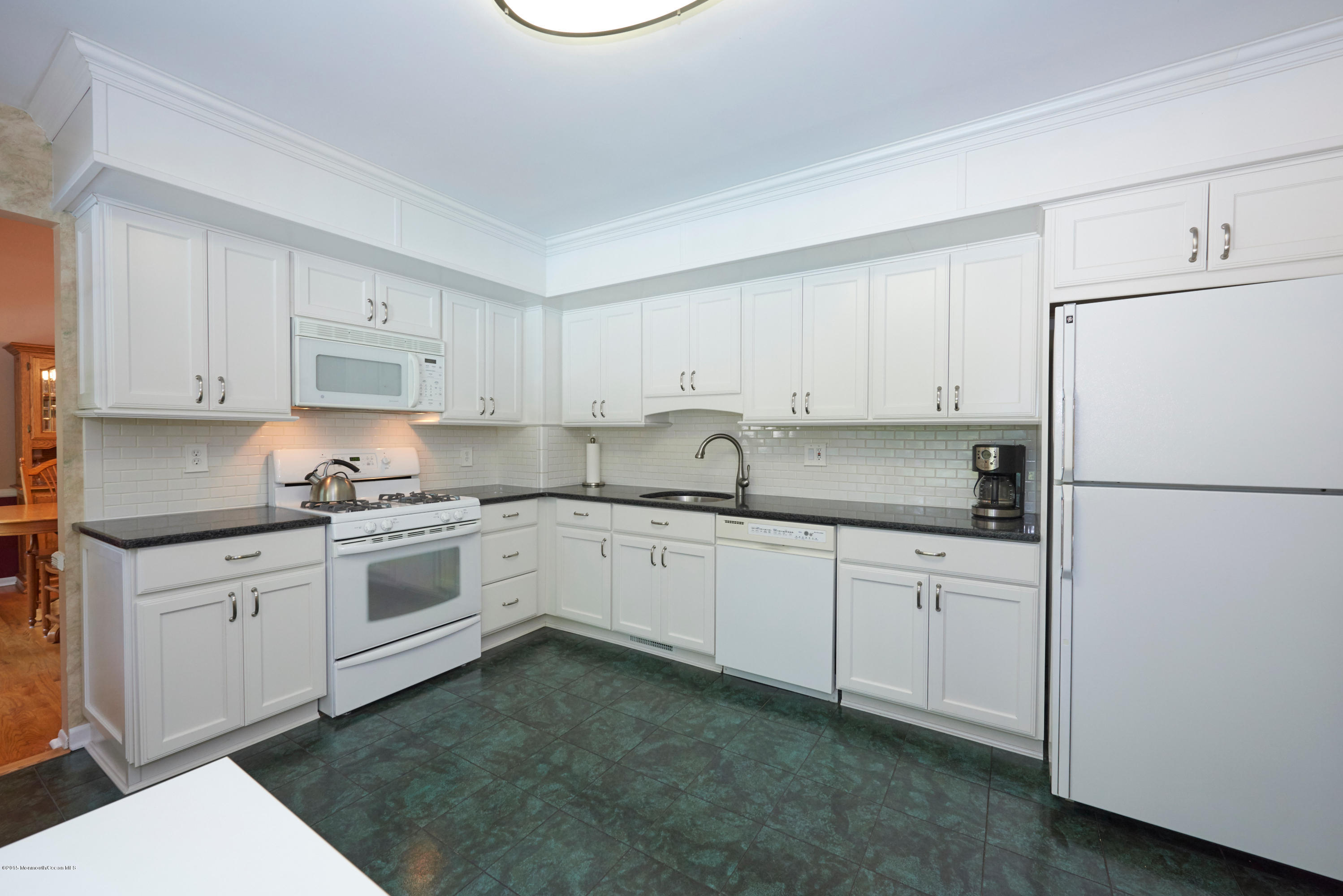21 Crest Road Middletown, NJ 07748 - Photo 17 of 34 a kitchen with granite countertop cabinets appliances a sink and a white counter top