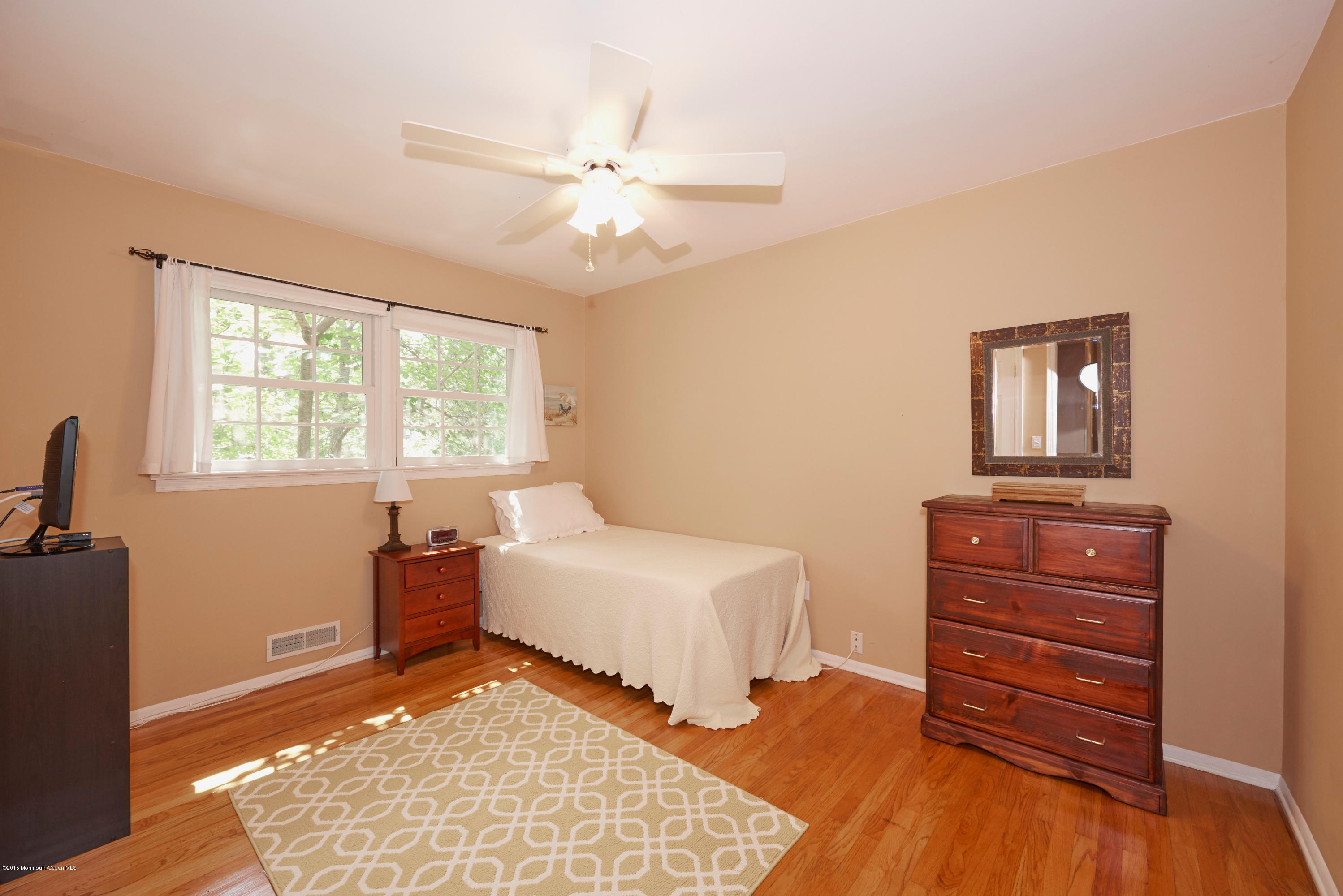 21 Crest Road Middletown, NJ 07748 - Photo 23 of 34 a bedroom with a bed and a dresser
