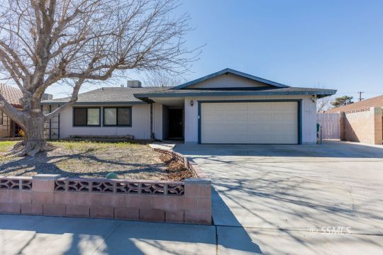 517 Randall Street Ridgecrest, CA 93555 - Photo 2 of 28 a view of a house with a yard and garage