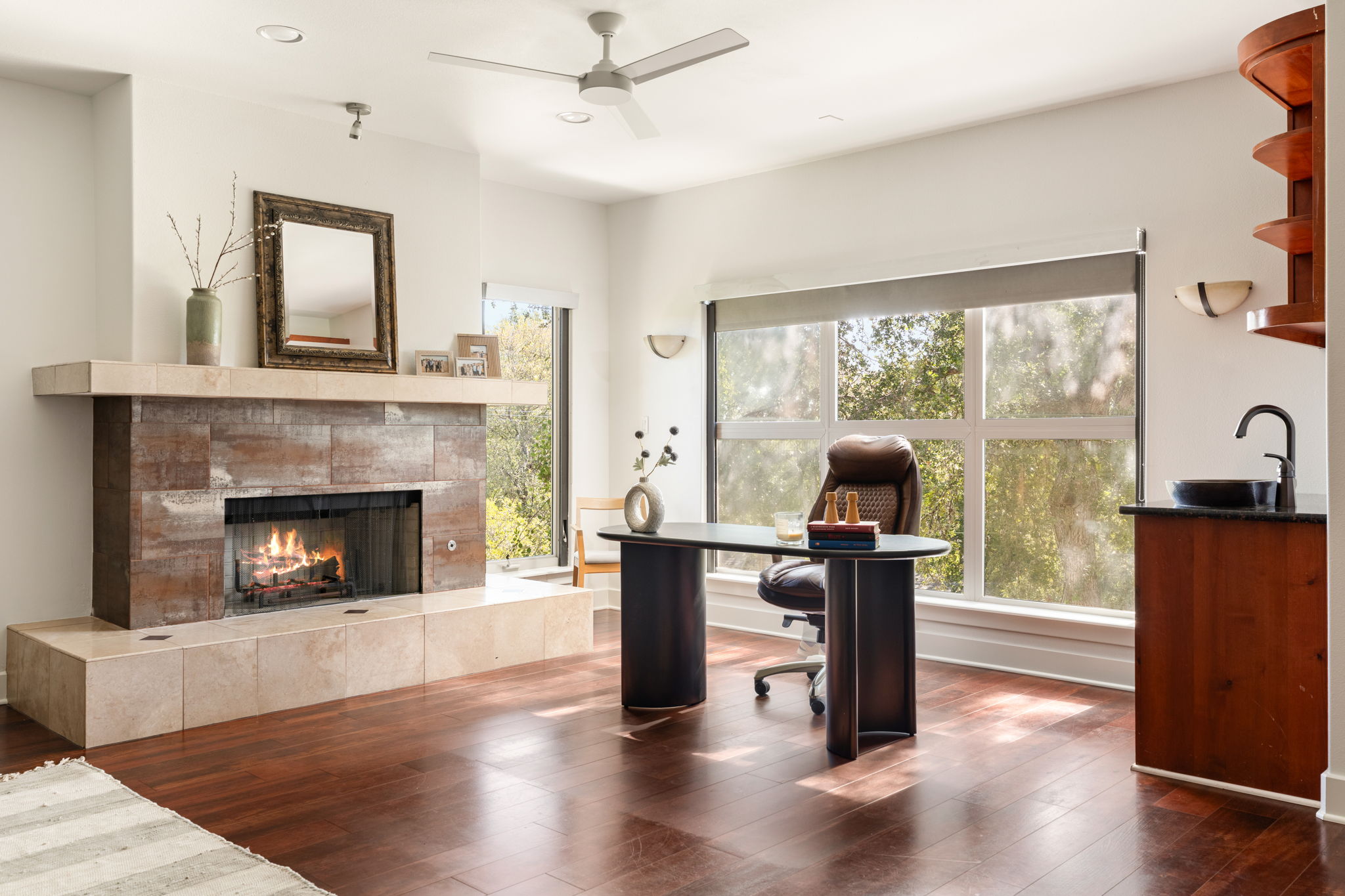 2324 Kinney Road Austin, TX 78704 - Photo 26 of 35 Rich hardwood floors and a tiled fireplace elevate this versatile home office space.
