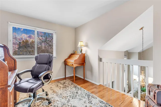 a bedroom with furniture and a large window