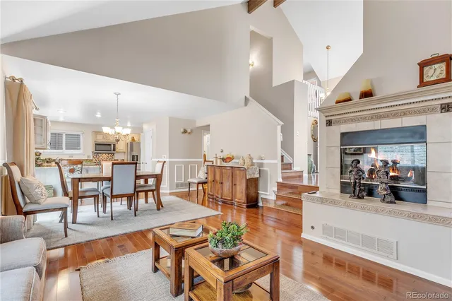 a living room with furniture a dining table and a potted plant