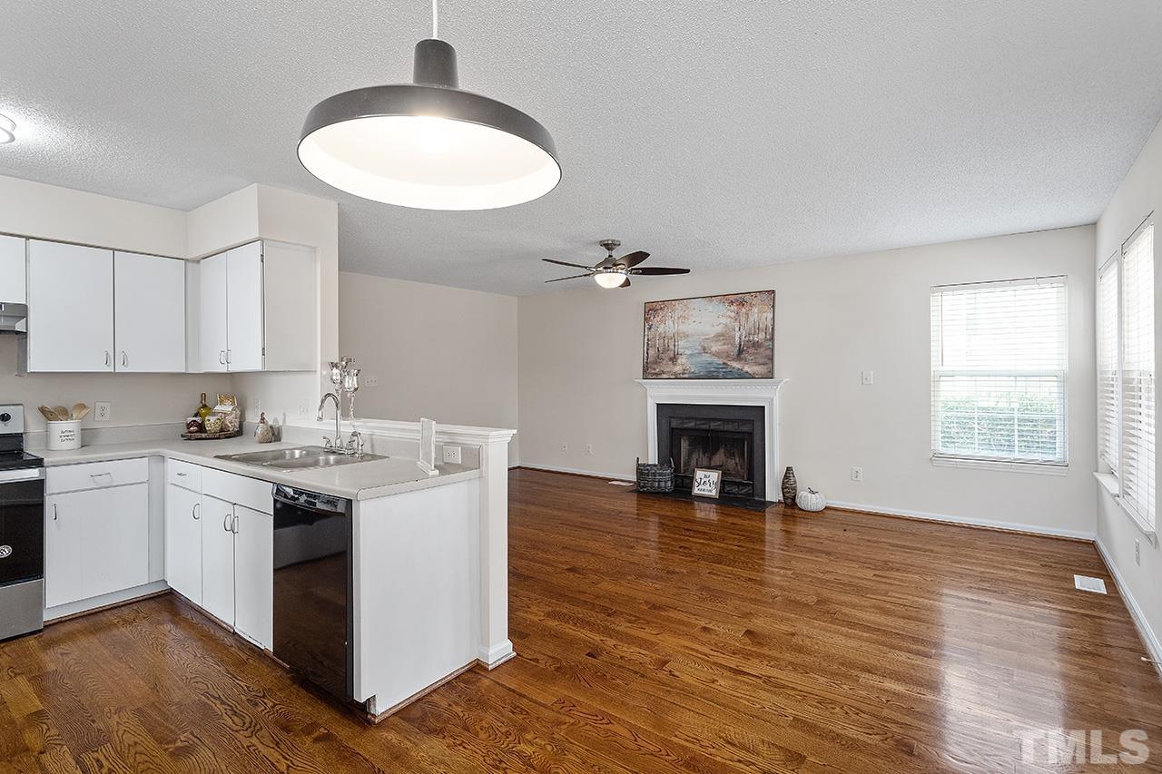 5504 Botany Bay Drive Raleigh, NC 27616 - Photo 12 of 23 a kitchen with a sink and a fireplace