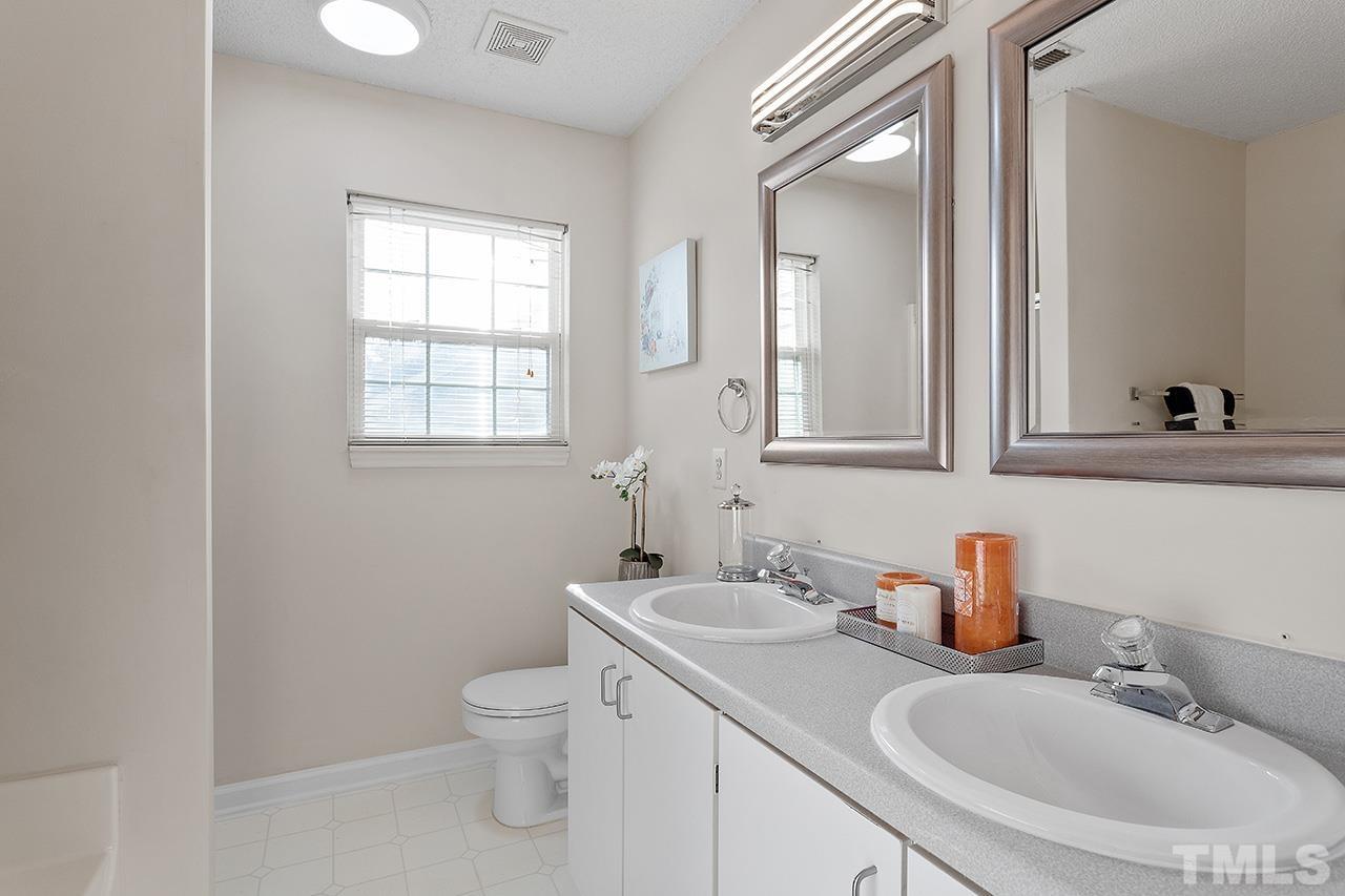 5504 Botany Bay Drive Raleigh, NC 27616 - Photo 16 of 23 a bathroom with a sink toilet and a mirror